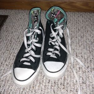 Black high top converse with pattern on inside